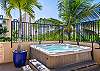 Unwind in the bubbling hot tub beneath swaying palms—a peaceful retreat where island breezes meet Waikiki relaxation.
