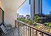 Step onto your private lanai to enjoy coffee among the palms and city skyline views—an inviting touch of outdoor living in the heart of Waikiki.