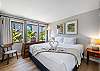 Rest easy in a peaceful bedroom with a king bed, room-darkening curtains, and a calming tropical view just steps from the beach.