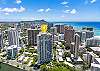 This wider aerial view marks The Watermark Waikiki beside Ala Wai Canal and places the building within Honolulu’s high-rise landscape, with Diamond Head, the coastline, and Pacific Ocean visible beyond the neighborhood.