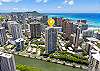 A yellow location marker identifies The Watermark beside Ala Wai Canal in this aerial view, with Waikiki’s high-rises, Diamond Head, and the Pacific Ocean illustrating the condo’s broader setting near western Waikiki.