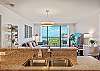 From the kitchen sink and granite breakfast bar, the open layout carries through the dining and living areas to the furnished lanai/balcony and Pacific Ocean view, keeping the scenery present during daily routines.