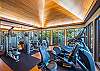 The Watermark Waikiki’s shared fitness center offers cardio and strength-training equipment in a wood-finished, window-lined room, helping guests maintain established routines during longer Honolulu stays.