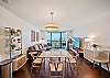 The open-plan dining area seats four and connects naturally with the living room, while full-height glass draws the Pacific Ocean and Ala Wai Boat Harbor views into everyday meals and longer stays in Waikiki.
