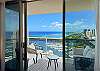 Floor-to-ceiling glass frames the furnished lanai/balcony and sweeping Pacific Ocean and Ala Wai Boat Harbor views from this 35th-floor Waikiki condo—an inviting backdrop for an extended Honolulu stay.