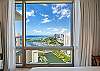 This closer guest-bedroom view showcases the 35th-floor perspective across Ala Wai Canal and Ala Wai Boat Harbor to the Pacific Ocean, with Honolulu’s urban shoreline completing the wide waterfront outlook.