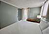 Bedroom with Sliding Door Open into Living Room