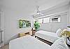 This bright twin bedroom offers flexible sleeping space with two comfortable beds and a mounted TV—ideal for relaxing after a day exploring Waikiki and nearby beaches.