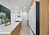 This sleek galley kitchen blends clean lines and bright lighting, offering a functional space to cook, gather, and recharge between Honolulu adventures.