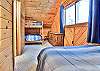 The loft area of Country Loft has a bunk bed (Twin over Full) and a Queen sized bed.