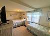 Cottage bedroom has queen and twin bed.