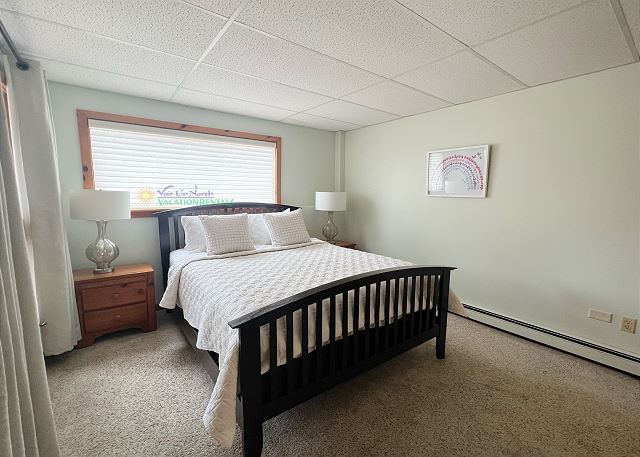 Lower-level bedroom with queen bed