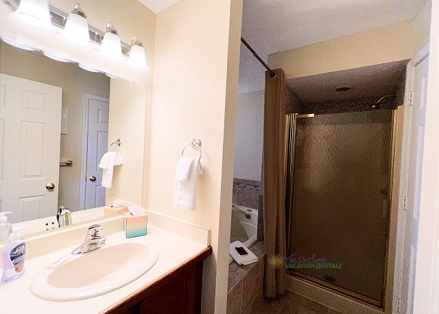 Bathroom with walk-in shower and jetted tub. 