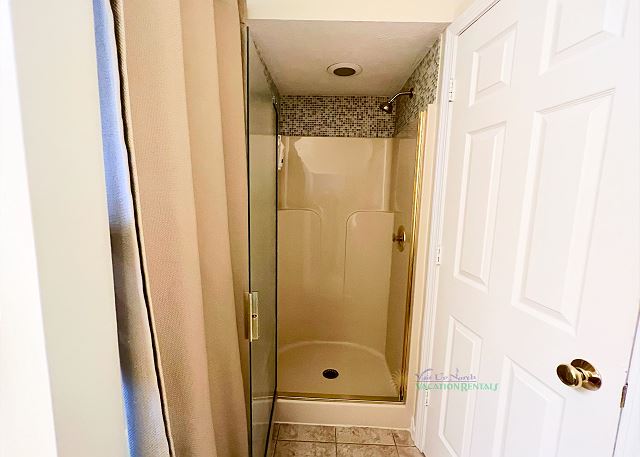 Bathroom with walk-in shower.