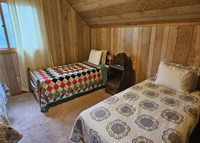 Upstairs bedroom with queen bed and two twins