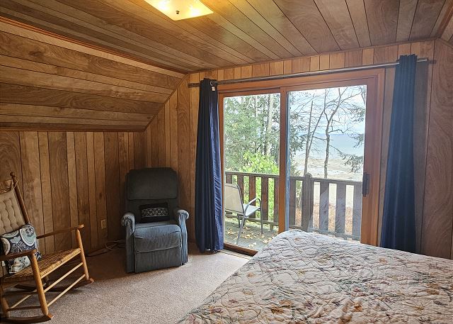 Upstairs bedroom with king bed and balcony