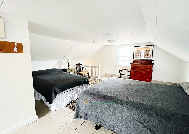 Upstairs loft with queen bed, full bed, and en suite bathroom. 