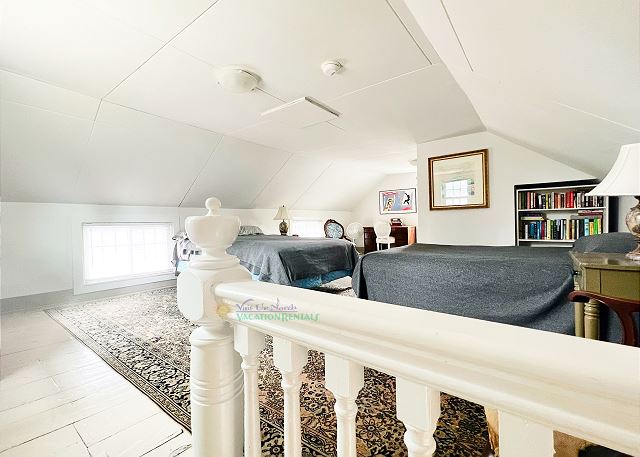 Upstairs loft with queen bed, full bed, and en suite bathroom. 