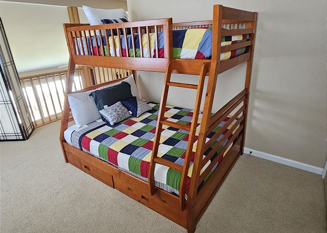 Twin-over-full bunk beds in loft