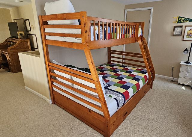 Twin-over-full bunk beds in loft