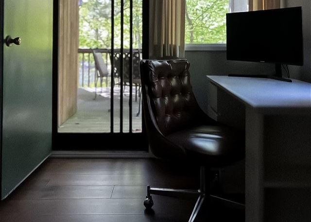 Computer monitor and desk in ground floor queen bedroom