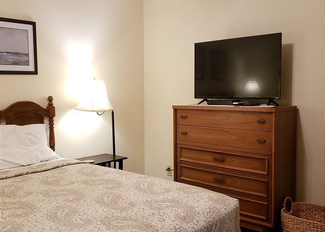 Queen size bedroom with TV.