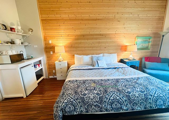 Guest house with king bed, futon, small kitchenette and bathroom.