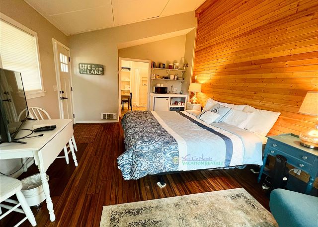 Guest house with king bed, futon, small kitchenette and bathroom.