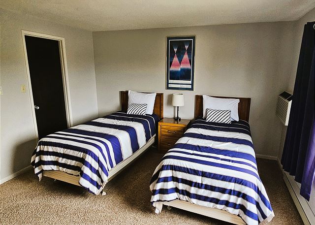 Upper-level bedroom with two twin beds