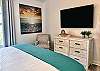 Unwind from your day in the master bedroom by catching your favorite show on the 55