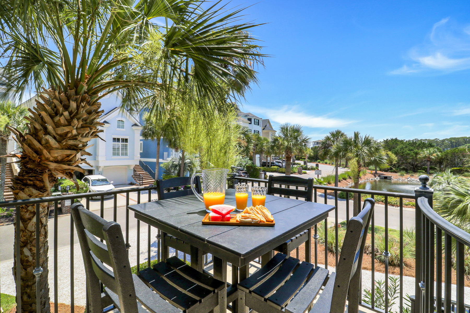 1 Collier Beach Road | Poolside lounge chairs and 4 seat table