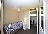 Upstairs second bedroom with King single bed, balcony and river & marina views
