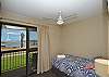 Upstairs  second bedroom with king single bed with balcony & views over the river and marina.