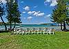 Association shared beach area with chairs and a sandy lakefront 