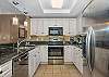 Posh kitchen with black granite and stainless steel appliances