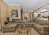 Uniquely decorated, this living room has a huge, comfy sectional sofa in the living to lounge on.