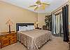 This roomy master bedroom has a king sized bed and access to the balcony.
