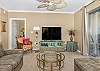 This one-of-a-kind living room has a large flat screen tv and specialty ceiling fan.