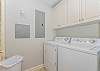 The laundry room is off the kitchen and has a full-sized washer and dryer.