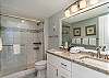 Remodeled ensuite with tiled walk-in shower and double vanity. 