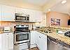 The remodeled kitchen has stainless steel appliances, granite countertops and reface cabinets. 