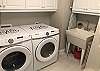 Full sized, front load washer and dryer in the laundry room off the kitchen.