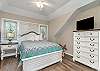 This cozy upstairs guest bedroom has a queen sized bed. 