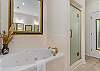 The primary ensuite has a wonderful jetted soaker tub and a separate shower.