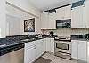 The modern kitchen has all stainless steel appliances, granite counters and re-faced cabinets. 