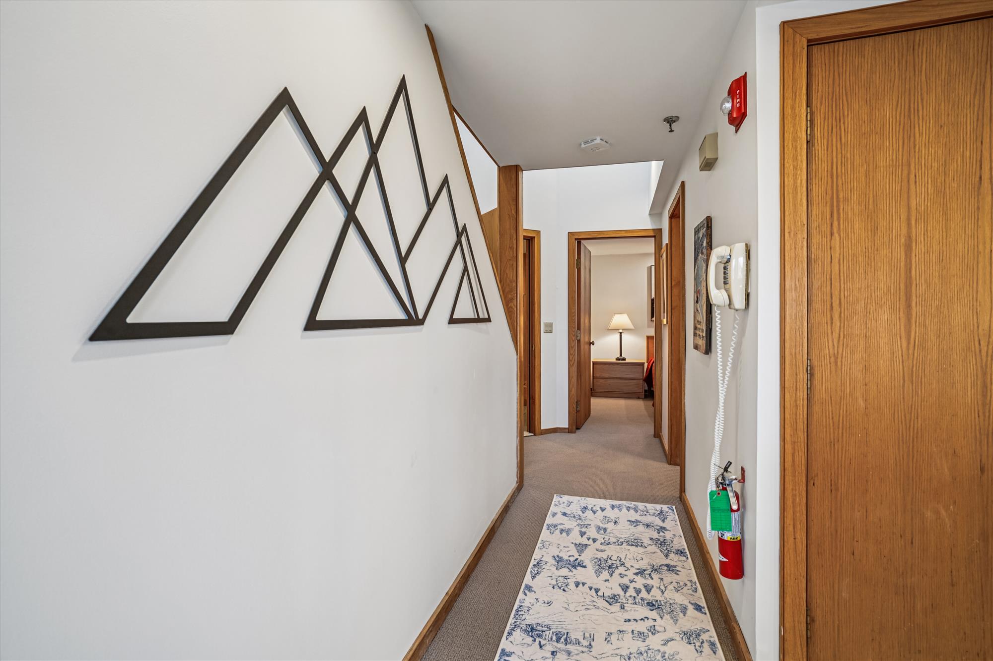 Hallway with Staircase & Mountain-Inspired Decor