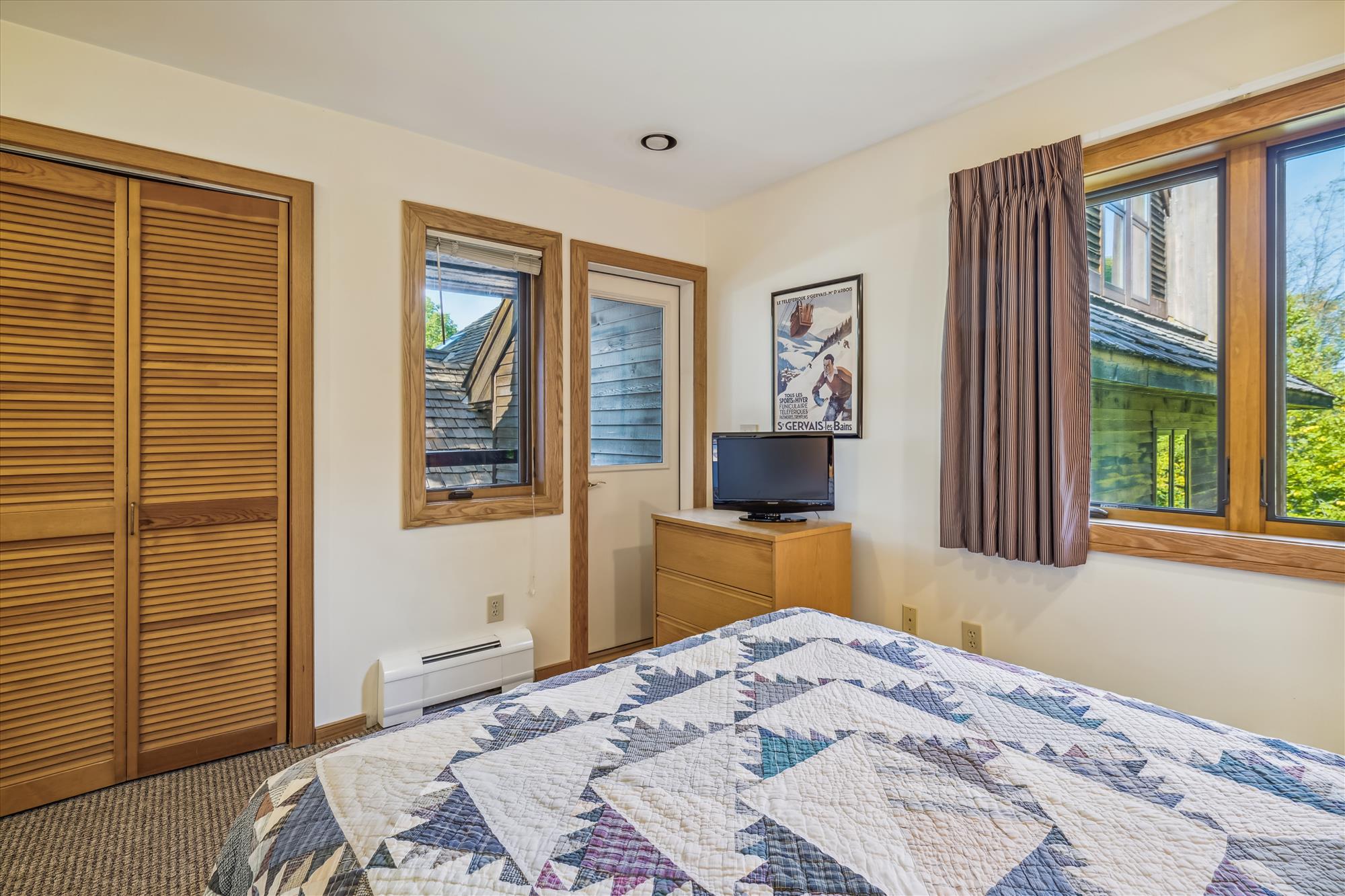 Bedroom with TV and Wooded Views