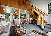 Dining area in the back with stairs leading up to the loft bedroom with queen bed.