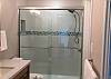 Beautifully tiled shower with glass doors