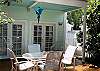 Double french doors leading to deck with outdoor dining